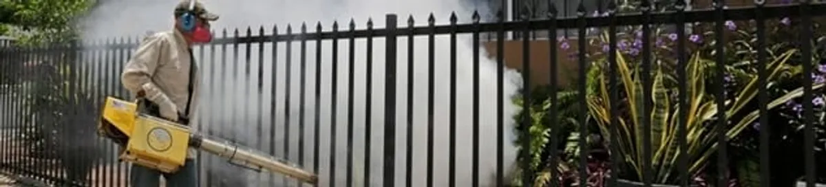 Mosquito control technician fogging a yard perimeter for mosquito reduction in Boise, ID